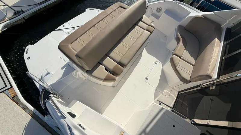 Slide: The Image of Spacious Aft Deck Seating Area The aft deck of the 2014 Regal 46 Sport Coupe offers ample seating with luxurious tan upholstery, perfect for relaxation and entertainment. The layout includes a convertible bench seat and a curved lounge, providing versatile options for guests. Surrounde - 6857465
