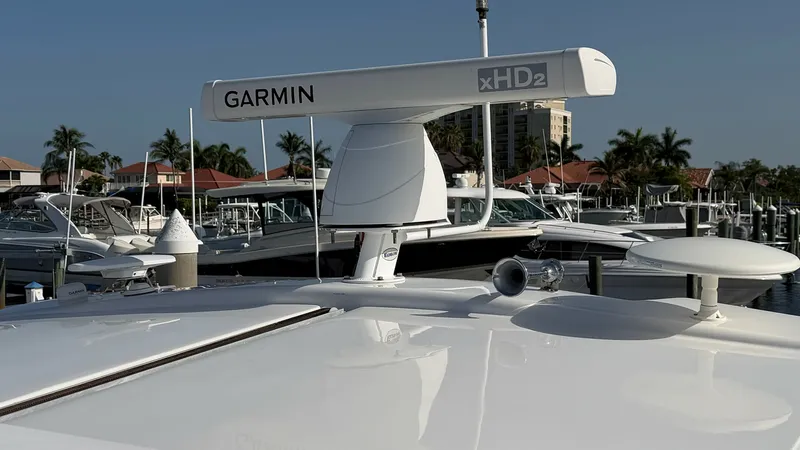 Slide: The Image of Flybridge Electronic Navigation Array The flybridge of the Regal 46 Sport Coupe features a state-of-the-art Garmin xHD2 radar system, ensuring precise navigation. The sleek design complements the vessel's modern aesthetics, while advanced technology offers reliability at sea. This setup enhan - 6857471