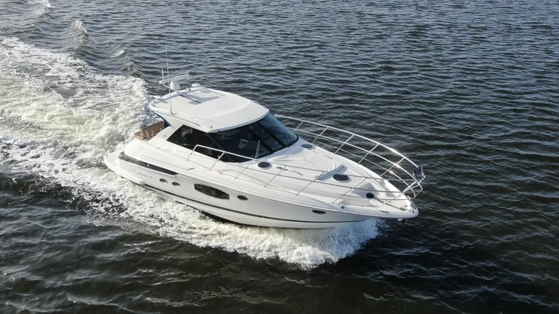 Slide: The Image of Aerial View of Regal 46 Sport Coupe This aerial shot showcases the sleek design of the 2014 Regal 46 Sport Coupe as it cruises through the water. The vessel's aerodynamic lines and expansive windows contribute to its modern aesthetic, while the spacious bow area offers ample room for relaxa - 6857479