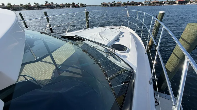 Slide: The Image of Bow View with Expansive Deck The bow of the 2014 Regal 46 Sport Coupe offers a spacious deck area, perfect for lounging and enjoying the open water views. The sleek design is complemented by sturdy stainless steel railings, ensuring safety and style. This area provides an inviting sp - 6857468