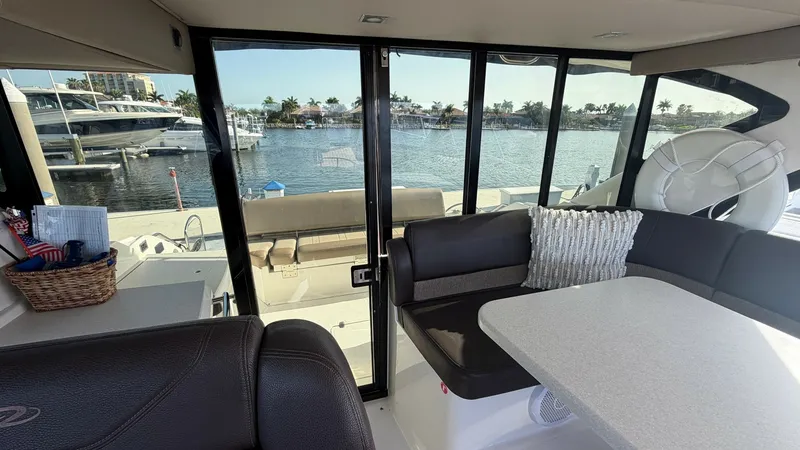 Slide: The Image of Salon with Panoramic Glass Doors The salon of the 2014 Regal 46 Sport Coupe offers a seamless indoor-outdoor experience with its panoramic glass doors leading to the aft deck. Luxurious leather seating and a sleek table create a welcoming space for relaxation and entertainment. The expan - 6857457