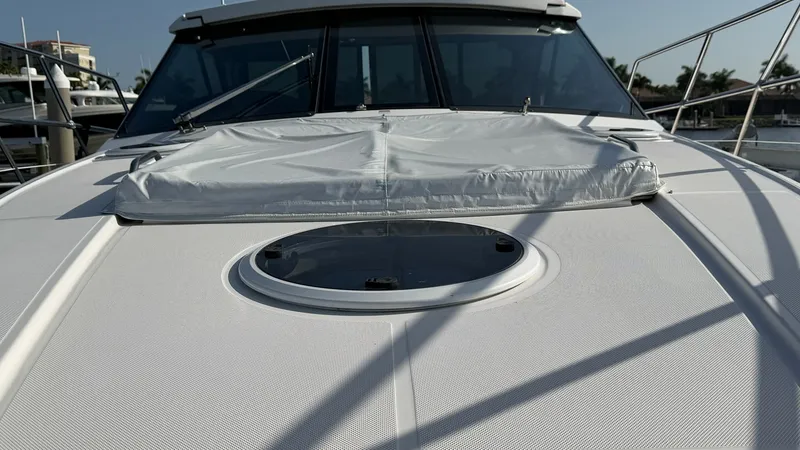 Slide: The Image of Foredeck with Sunpad and Hatch The foredeck of the 2014 Regal 46 Sport Coupe features a spacious sunpad, perfect for relaxation under the sun. The central hatch provides both natural light and ventilation to the cabin below, enhancing the comfort of the interior space. Stainless steel - 6857470