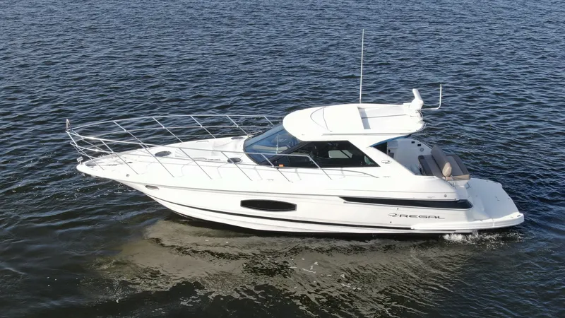Slide: The Image of Aerial View of Sport Coupe Exterior This image showcases the sleek exterior of the 2014 Regal 46 Sport Coupe, 'Serenity in the Sea'. The streamlined design enhances its aerodynamic efficiency while the expansive windows offer panoramic views from the interior. The spacious aft deck is perfe - 6857484
