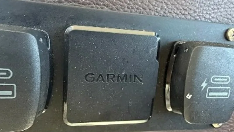 Slide: The Image of Garmin Electronics Control Panel This image showcases the Garmin electronics control panel on the Regal 46 Sport Coupe. The panel features prominent, easy-to-use switches for seamless navigation and control. Its sleek design integrates perfectly into the vessel's sophisticated console, o - 6857455