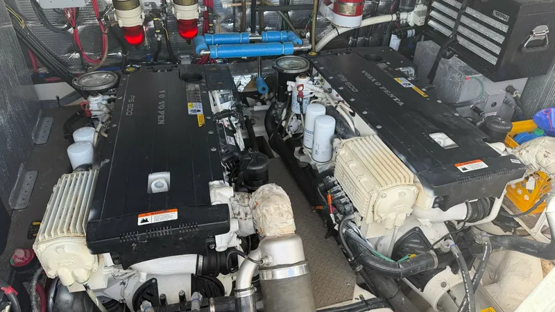 Slide: The Image of Engine Room with Twin Engines The engine room of the 2014 Regal 46 Sport Coupe showcases twin powerful engines, meticulously maintained to ensure optimal performance. The space is well-organized, with clearly labeled components and efficient use of space, reflecting the manufacturer's - 6857476