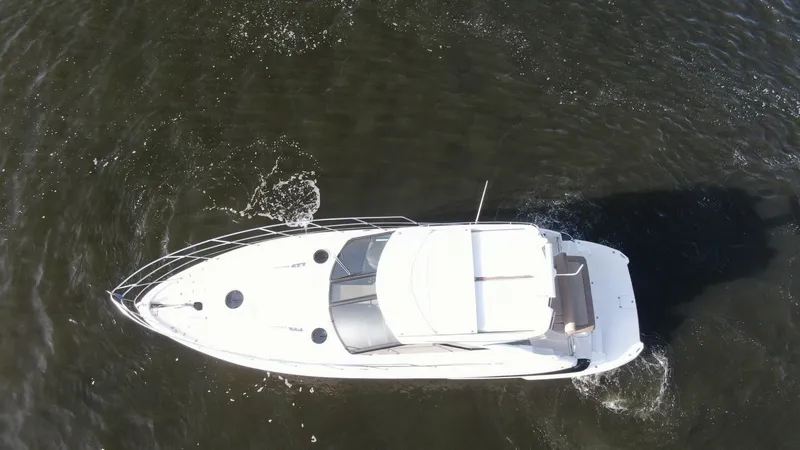 Slide: The Image of Aerial View of Sport Coupe Deck This aerial perspective showcases the sleek design of the Regal 46 Sport Coupe's deck. The vessel features a spacious sunroof and a well-defined bow area, providing ample natural light and visibility. Its streamlined structure is complemented by elegant r - 6857480
