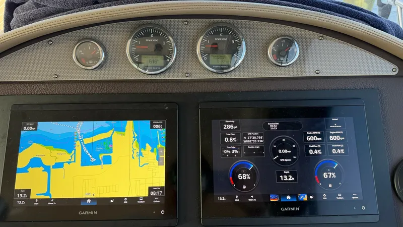Slide: The Image of Helm Electronics and Navigation Display The helm of the 2014 Regal 46 Sport Coupe showcases advanced Garmin navigation systems and engine monitoring displays. Dual screens provide detailed chart plotting and essential vessel data for optimal navigation. The ergonomic layout ensures easy access - 6857446