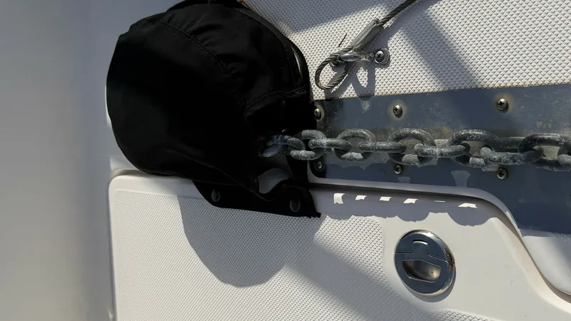 Slide: The Image of Anchor Chain and Capstan Detail This image showcases the anchor chain system of the 2014 Regal 46 Sport Coupe, highlighting the robust stainless steel capstan. The design ensures secure and efficient anchoring, complemented by a protective cover to maintain the chain's durability. The t - 6857472