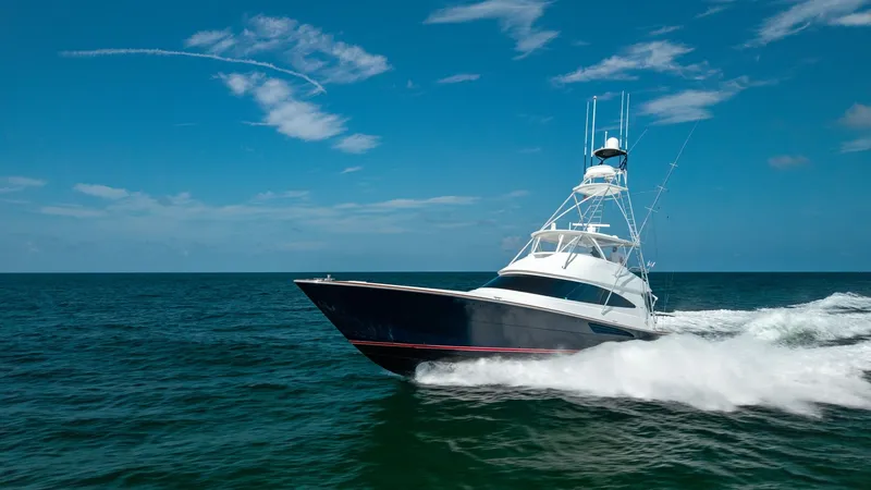 Slide: The Image of Dynamic Bow View at Sea The 2022 Viking 68 Convertible, 'Tax Man,' is majestically captured slicing through the ocean waves. Its sleek hull design and powerful stance emphasize the vessel's superior performance and luxury. The vibrant blue sky and open water backdrop enhance the - 7463837