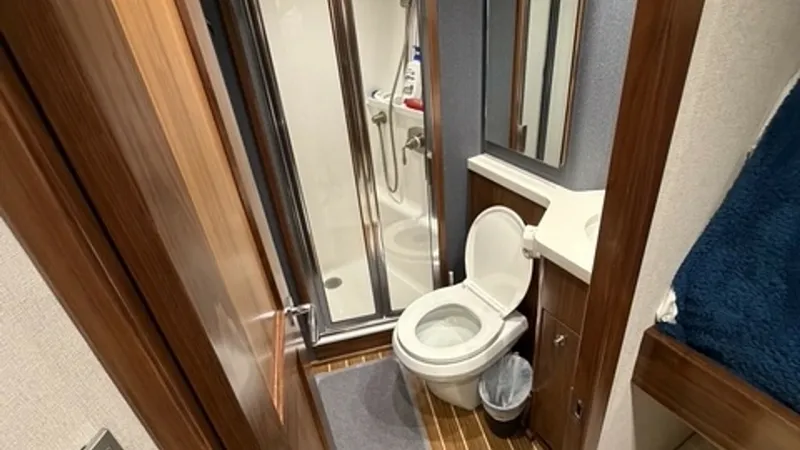 Slide: The Image of Port Guest Head Teak and holly style sole with an enclosed shower. - 6862349