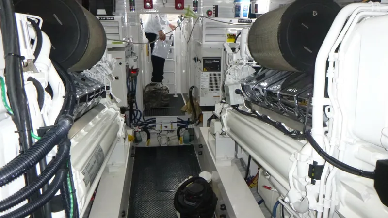 Slide: The Image of Engine Room with Dual Engines This image showcases the well-organized engine room of the 2022 Viking 68 Convertible, featuring dual powerful engines. The space is meticulously designed for functionality, with easy access to controls and maintenance areas. The sleek, polished surfaces - 6862362