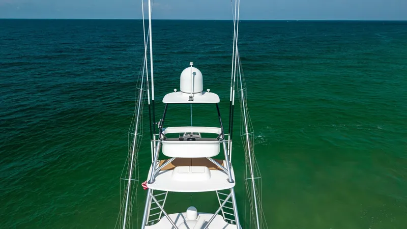 Slide: The Image of Flybridge and Tuna Tower View This image showcases the flybridge and tuna tower of the 2022 Viking 68 Convertible, 'Tax Man'. The sleek design offers a commanding view of the ocean, enhancing visibility for navigation and fishing. The flybridge is equipped with state-of-the-art contro - 7463828