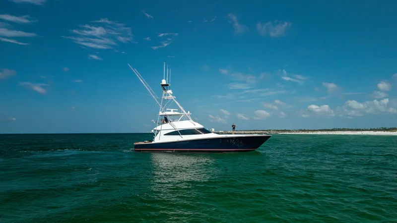 Slide: The Image of Side Profile of Viking 68 Convertible The Viking 68 Convertible cuts a striking figure against the ocean backdrop, showcasing its sleek lines and robust design. The vessel's elegant hull and towering superstructure demonstrate the craftsmanship Viking is renowned for. This side profile highli - 7463834