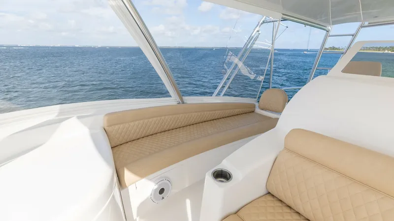 Slide: The Image of Bridge Lounge with Panoramic Views The bridge lounge of the 2022 Viking 68 Convertible offers plush seating with elegant diamond-stitched upholstery, ensuring comfort and style. Large windows provide expansive panoramic views of the open sea, enhancing the luxurious experience. The space i - 7463826