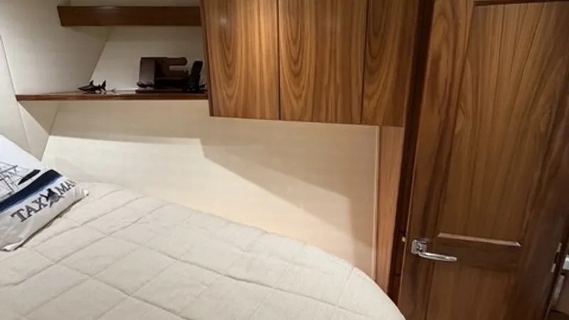 Slide: The Image of Viking 68 Convertible Forward Stateroom Forward Stateroom with elegant walnut storage. - 6862342
