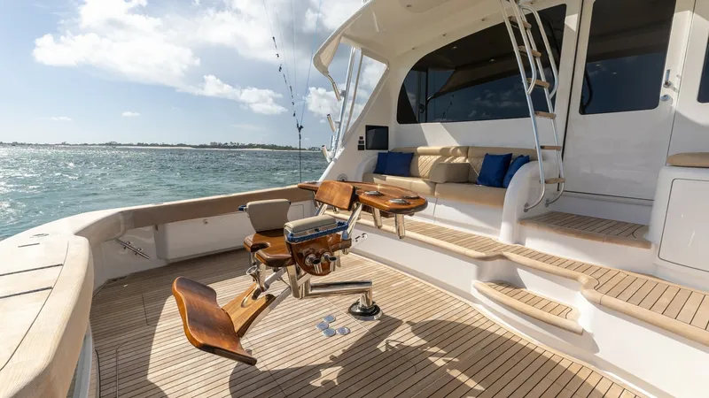 Slide: The Image of Spacious Aft Deck with Seating The aft deck of the 2022 Viking 68 Convertible features a luxurious teak finish, offering ample space for relaxation and fishing. Equipped with comfortable seating and a sturdy fighting chair, this area is perfect for both leisure and sport. The seamless - 7463792
