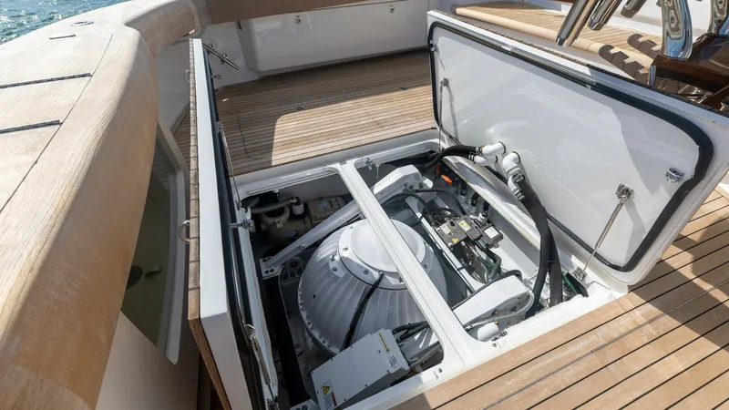 Slide: The Image of Engine Compartment Access Hatch This image showcases the engine compartment of the 2022 Viking 68 Convertible, featuring a neatly organized and accessible layout. The hatch opens to reveal advanced mechanical systems, highlighting the vessel's commitment to performance and efficiency. T - 7463797
