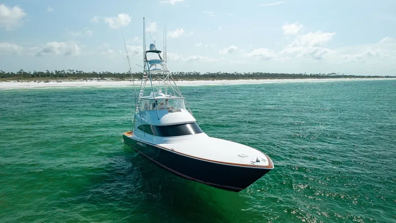 Slide: The Image of Aerial Bow View in Open Water This stunning aerial shot highlights the sleek bow of the 2022 Viking 68 Convertible, 'Tax Man'. The yacht's refined lines and robust structure are perfectly showcased against the vibrant blue-green waters. The open ocean backdrop enhances the vessel's po - 7463832