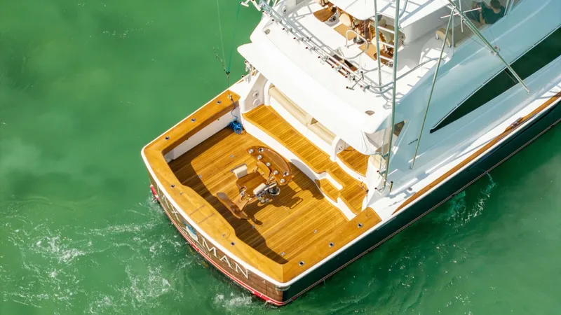 Slide: The Image of Aerial View of Aft Deck Experience the sleek design of the Viking 68 Convertible's aft deck, showcasing a spacious teak platform perfect for fishing or leisure. The area is equipped with a sturdy fighting chair and ample space for movement, ideal for sportfishing enthusiasts. Th - 7463831