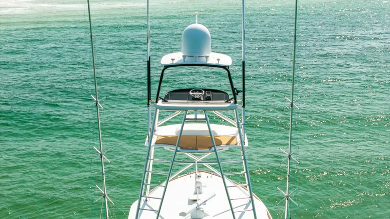 Slide: The Image of Tower and Helm Station View This image showcases the tower and helm station of the 2022 Viking 68 Convertible, Tax Man. The elevated position offers a commanding view of the surroundings, ideal for navigation and sportfishing. The sleek design and robust structure reflect Viking's c - 7463829