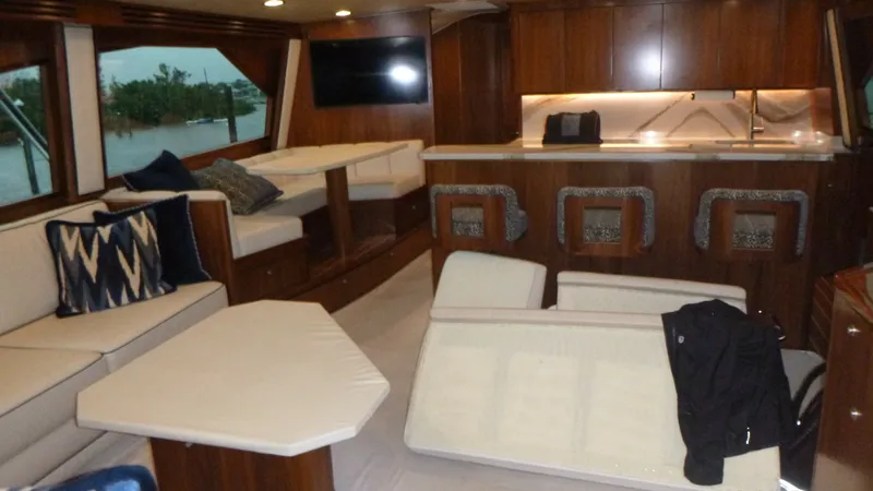 Slide: The Image of Luxurious Salon and Galley Area The salon of the 2022 Viking 68 Convertible offers a spacious and inviting atmosphere, featuring plush seating with elegant cushions and a modern, open layout. The galley is equipped with sleek countertops and state-of-the-art appliances, perfect for ente - 6862329