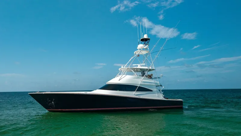 The Image of Side Profile of Viking 68 Convertible The sleek side profile of the 2022 Viking 68 Convertible, 'Tax Man,' showcases its elegant lines and robust build. The vessel's striking dark hull contrasts beautifully with the bright superstructure, while the towering flybridge emphasizes its sportfishi - 7463787