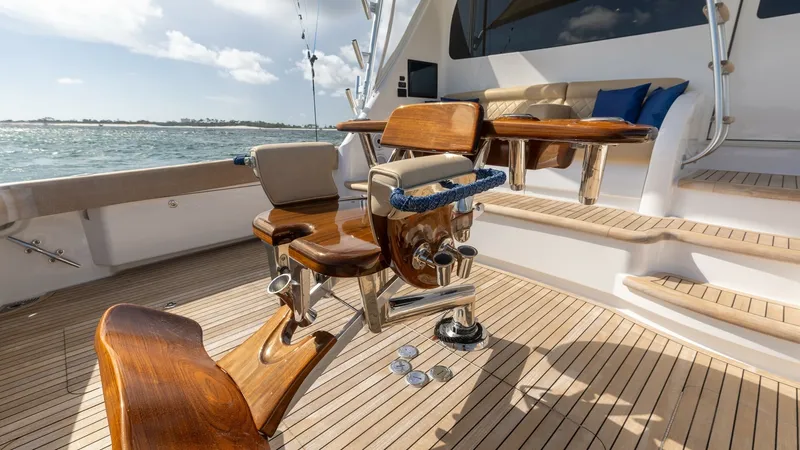 Slide: The Image of Cockpit with Teak Decking and Seating This Viking 68 Convertible showcases a spacious cockpit featuring elegant teak decking. The well-appointed seating area offers plush cushions for comfort, complemented by a high-quality fighting chair, ideal for fishing enthusiasts. The open design seamle - 7463795