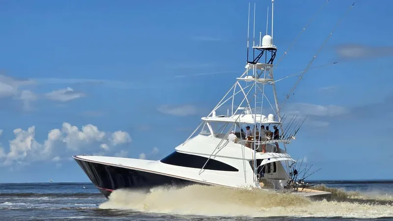 Slide: The Image of Viking 68 Convertible in Motion The 2022 Viking 68 Convertible, 'Tax Man', is captured powering through the waves with grace and agility. Its sleek hull design and robust tower showcase superior craftsmanship and engineering. The image highlights the vessel's dynamic performance and the - 6862367