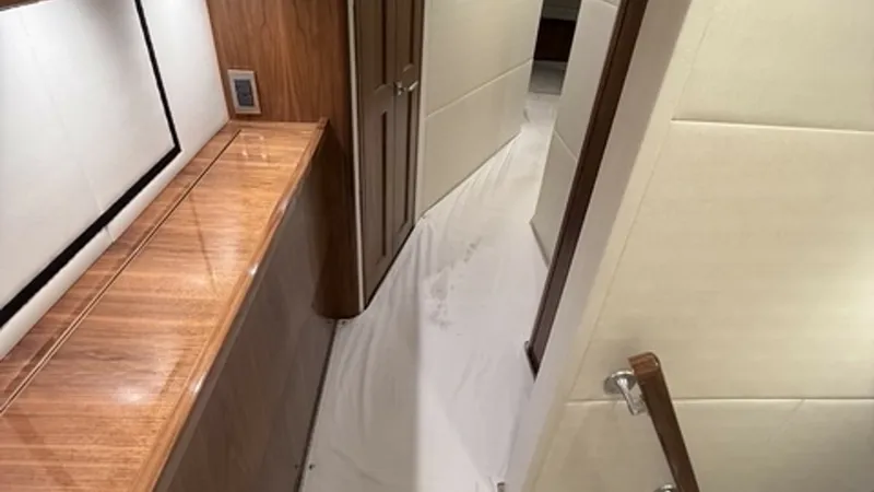 Slide: The Image of 2022 Viking 68 Convertible Companionway Companionway with durable carpet runner and elegant walnut woodworking. - 6862352