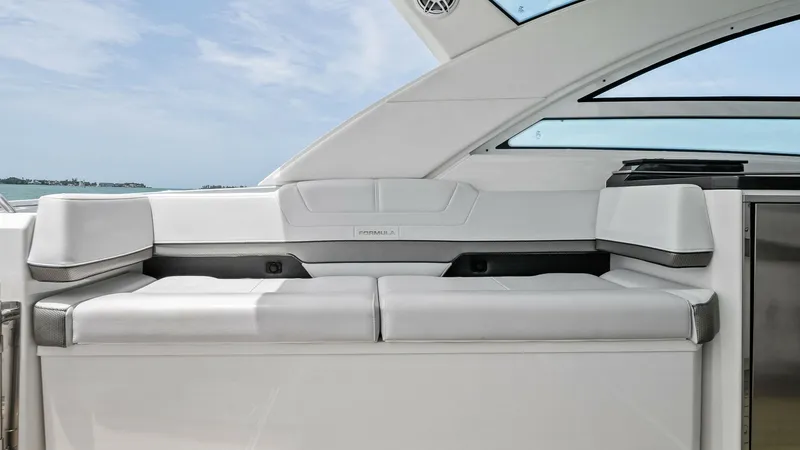 Slide: The Image of Cockpit Lounge Seating Area The cockpit of the 2022 Formula 430 Super Sport Crossover features a sleek, modern lounge area with plush white seating. Designed for comfort and style, the seating is complemented by large windows that offer expansive views and ample natural light. The d - 7030607