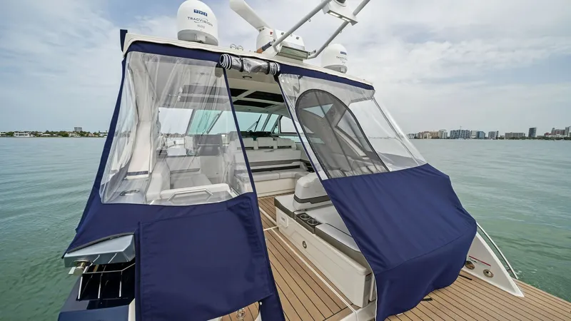 Slide: The Image of Aft Deck with Canvas Enclosure The aft deck of the 2022 Formula 430 Super Sport Crossover features a stylish canvas enclosure, providing both privacy and protection from the elements. The teak flooring adds a touch of elegance, while the spacious layout offers ample seating for relaxat - 7030599
