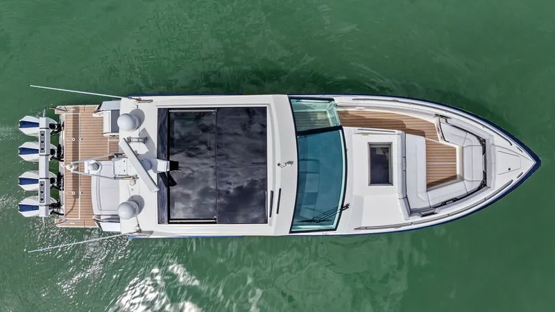 Slide: The Image of Aerial View of Deck Layout This aerial view of the 2022 Formula 430 Super Sport Crossover showcases its sleek design and spacious deck layout. The vessel features a sophisticated helm with a large windshield and ample seating areas, perfect for relaxation and entertainment. The ele - 7030646