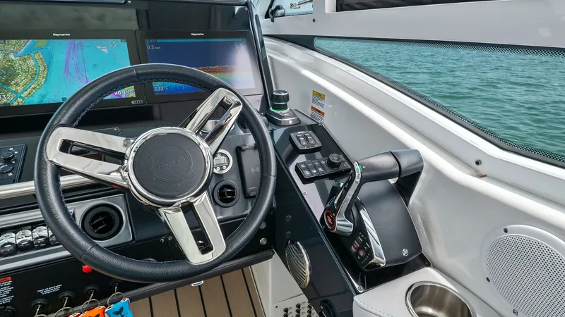 Slide: The Image of Helm Station with Navigation Displays The helm station of the 2022 Formula 430 Super Sport Crossover showcases a sleek steering wheel and advanced navigation displays, providing a state-of-the-art control center. The ergonomic design includes intuitive controls and comfortable seating for sup - 7030611