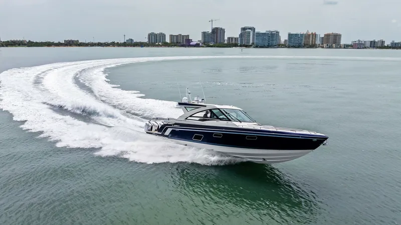 Slide: The Image of Dynamic Aerial View of Formula 430 The 2022 Formula 430 Super Sport Crossover, 'Blue Agave', showcases its sleek design and powerful performance as it cuts through the water. The vessel's deep blue hull contrasts elegantly with the white wake, highlighting its agility and speed. This image - 7030640