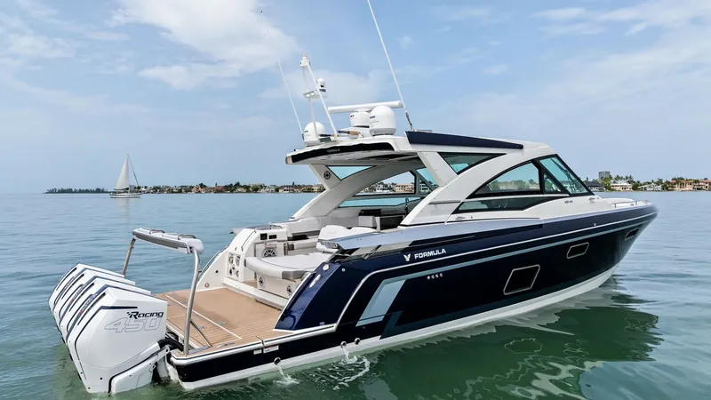 Slide: The Image of Sleek Aft Deck with Outboard Engines The 2022 Formula 430 Super Sport Crossover's aft deck showcases a spacious layout with elegant teak flooring. Equipped with powerful Mercury outboard engines, this vessel promises exceptional performance and speed. The modern design and luxurious finishes - 7030632