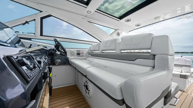 Slide: The Image of Helm and Cockpit Seating Area The helm of the Formula 430 Super Sport Crossover features a sleek, modern design with advanced navigation controls and a comfortable steering wheel. Adjacent to the helm, the cockpit offers plush, ergonomic seating with high-quality upholstery, ensuring - 7030614