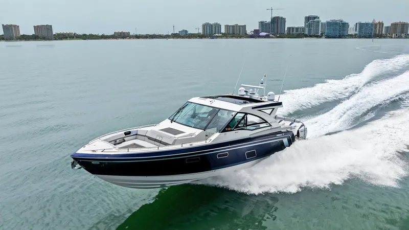 Slide: The Image of Dynamic Bow View in Motion The Formula 430 Super Sport Crossover, 'Blue Agave,' is captured gracefully cutting through the water. The sleek lines and sporty design highlight its performance capabilities, while the spacious bow area provides ample seating for relaxation. This 2022 m - 7030633