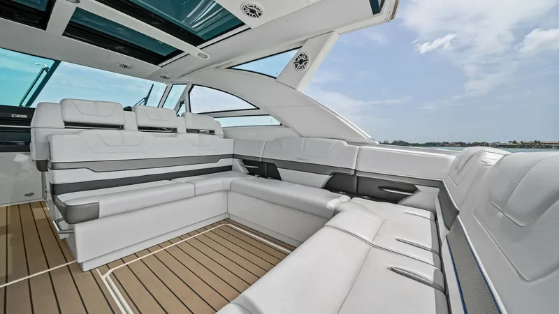 Slide: The Image of Spacious Cockpit Seating Area The 2022 Formula 430 Super Sport Crossover's cockpit features luxurious, wraparound seating with premium upholstery, offering comfort for guests. The open design, complemented by large windows and a retractable roof, provides a seamless blend of indoor an - 7030606