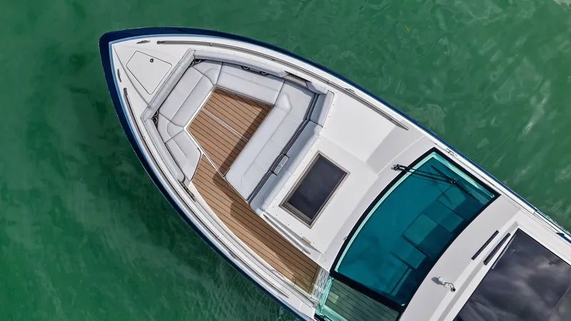 Slide: The Image of Bow Seating Area and Deck Layout This image showcases the spacious bow seating area of the 2022 Formula 430 Super Sport Crossover. The elegant teak decking complements the sleek white upholstery, creating a luxurious and inviting space. The integrated glass windshield offers protection w - 7030645