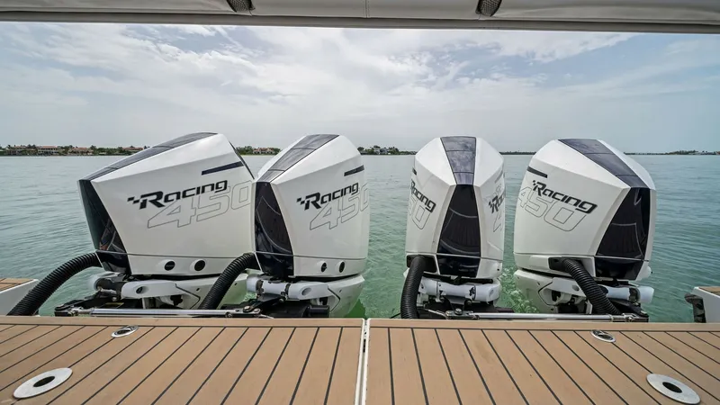 Slide: The Image of Quad Outboard Engines on Swim Platform The Blue Agave's 2022 Formula 430 Super Sport Crossover features a powerful setup with four Mercury Racing 450 outboard engines, ensuring unmatched performance and speed. The sleek design of these engines complements the yacht's modern aesthetic, while th - 7030593