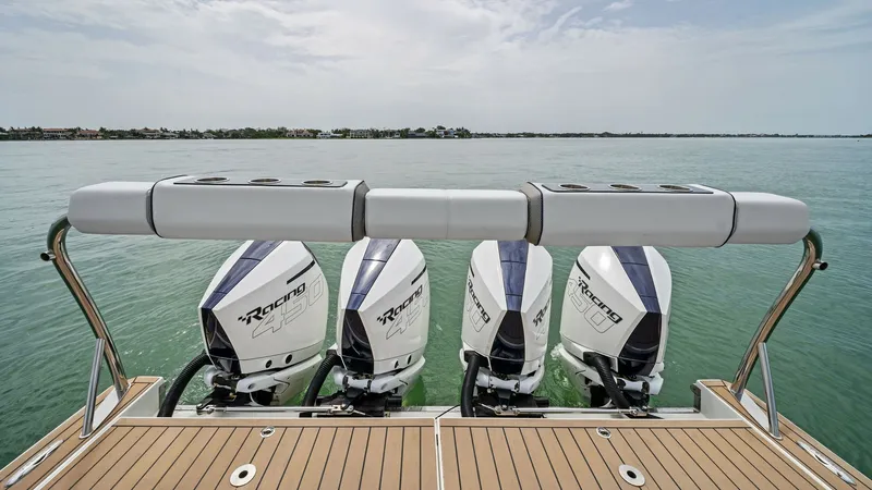Slide: The Image of Stern View with Quad Engines The 2022 Formula 430 Super Sport Crossover showcases its powerful quad Mercury Racing outboard engines, offering exceptional performance and speed. The teak swim platform provides a luxurious touch, enhancing the vessel's elegant design. This setup ensure - 7030595