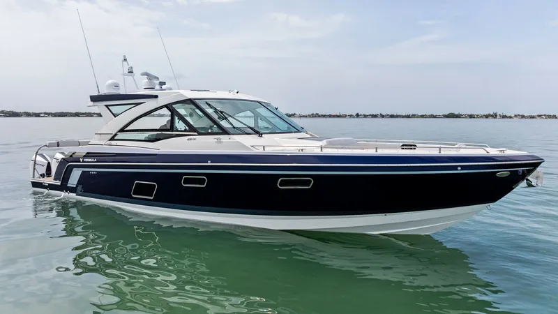 Slide: The Image of Profile View of 430 Super Sport Crossover The Formula 430 Super Sport Crossover showcases its sleek design and dynamic profile, highlighted by the elegant blue hull. This 2022 model, named Blue Agave, features expansive windows and a sporty silhouette, offering both luxury and performance on the - 7030631