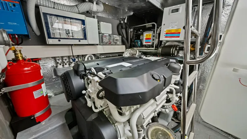 Slide: The Image of Engine Room with Modern Equipment The engine room of the 2026 Absolute Navetta 58, vessel ANDIAMO, showcases a meticulously organized space with state-of-the-art machinery. Featuring a robust engine setup, advanced control panels, and secure piping, the room is designed for optimal perfor - 7018674
