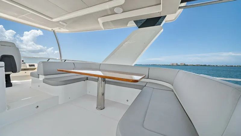 Slide: The Image of Flybridge Seating Area with Ocean View This spacious flybridge on the 2026 Absolute Navetta 58 features a comfortable L-shaped seating arrangement, perfect for socializing while enjoying panoramic ocean views. The elegant teak table provides a stylish setting for alfresco dining. With its slee - 7018667