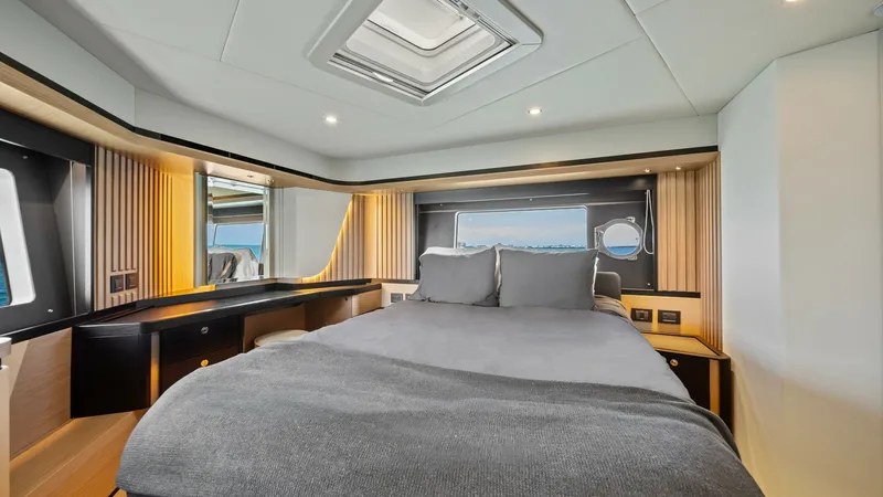 Slide: The Image of Elegant Master Stateroom The master stateroom on the Absolute Navetta 58 exudes luxury with its spacious layout and modern design. Featuring a plush double bed, stylish wood finishes, and ample natural light from the side windows, this space provides a serene retreat. The overhea - 7018648