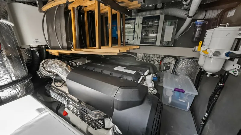 Slide: The Image of Engine Room with Advanced Systems The engine room of the 2026 Absolute Navetta 58 features a meticulously organized layout with state-of-the-art machinery. The central engine is complemented by advanced filtration systems and neatly arranged wiring, ensuring optimal performance and reliab - 7018676