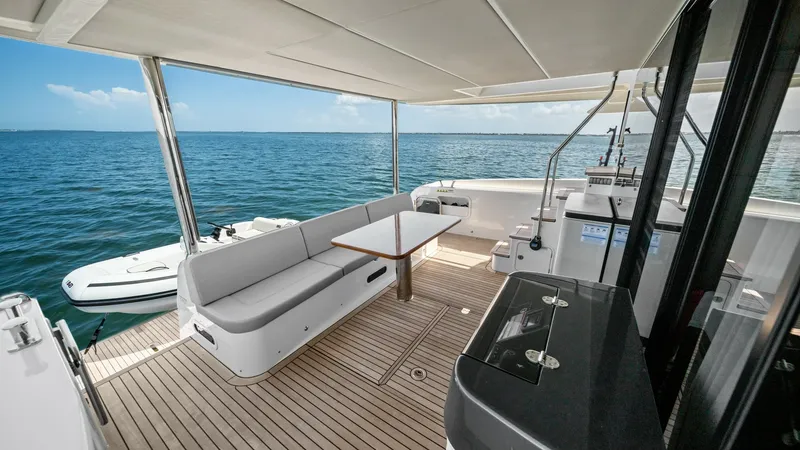 Slide: The Image of Spacious Aft Deck with Seating The aft deck of the 2026 Absolute Navetta 58 offers a luxurious outdoor retreat with ample seating and a sleek wooden table, perfect for alfresco dining. The elegant teak flooring complements the contemporary design, while the open layout provides unobstr - 7018653