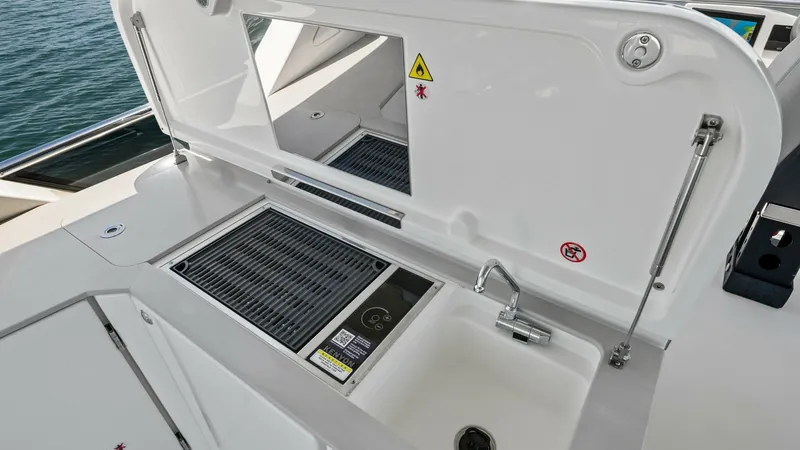 Slide: The Image of Flybridge Outdoor Kitchen Area This image showcases the spacious outdoor kitchen area on the flybridge of the Absolute Navetta 58. Equipped with a grill, sink, and ample counter space, this setup is perfect for alfresco dining and entertaining while enjoying panoramic sea views. The sl - 7018663