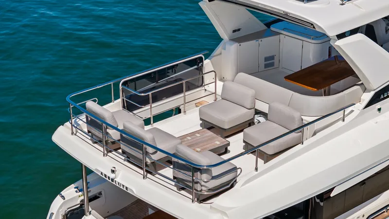 Slide: The Image of Flybridge Lounge Area The flybridge of the Absolute Navetta 58 offers a spacious and inviting lounge area, perfect for entertaining and relaxation. With plush seating and a sleek teak table, this space is designed for comfort and style. The open layout provides panoramic views - 7018684