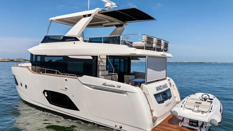 Slide: The Image of Aft Deck with Tender Storage The aft deck of the 2026 Absolute Navetta 58, named ANDIAMO, showcases a sleek design with a convenient tender storage platform. The spacious area includes a teak-finished deck, providing an elegant touch and easy access to the water. The modern canopy of - 7018687